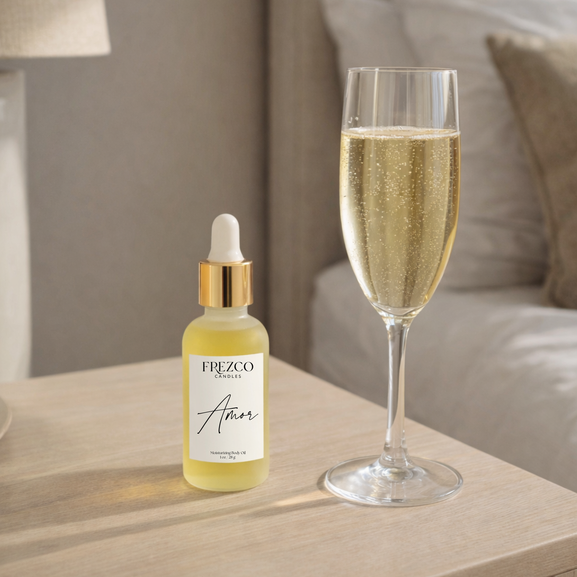 FREZCO Amor skincare dropper bottle next to a glass of champagne on a wooden surface.