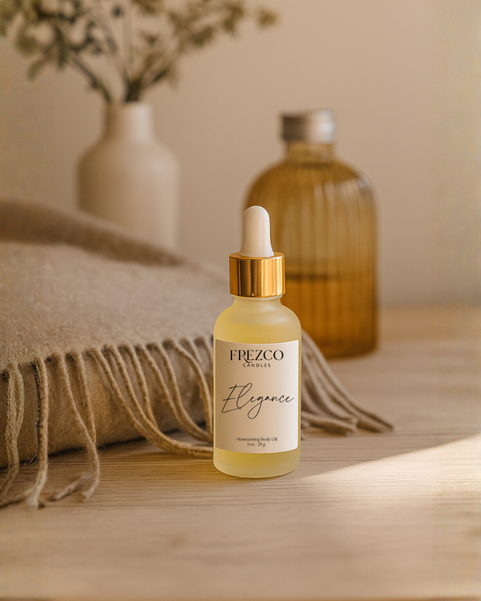 Frezco Candles Body Oil dropper bottle on a wooden surface with a blurred background