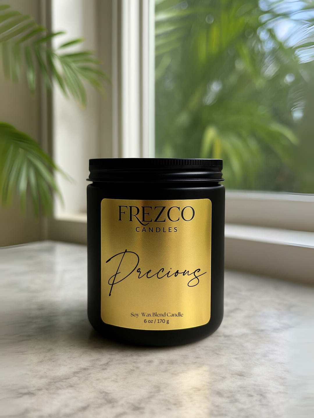 Frezco Candles Precious candle on a marble surface with a window and plants in the background