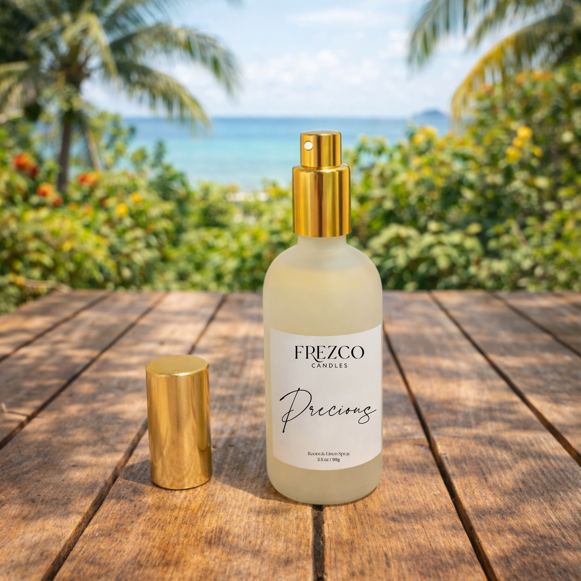 Frezco Candles perfume bottle with gold cap on a wooden surface with a tropical background
