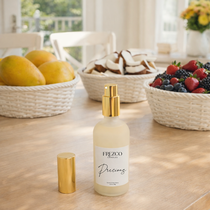 Frezco bottle labeled 'Precious' on a table with fruit bowls in the background