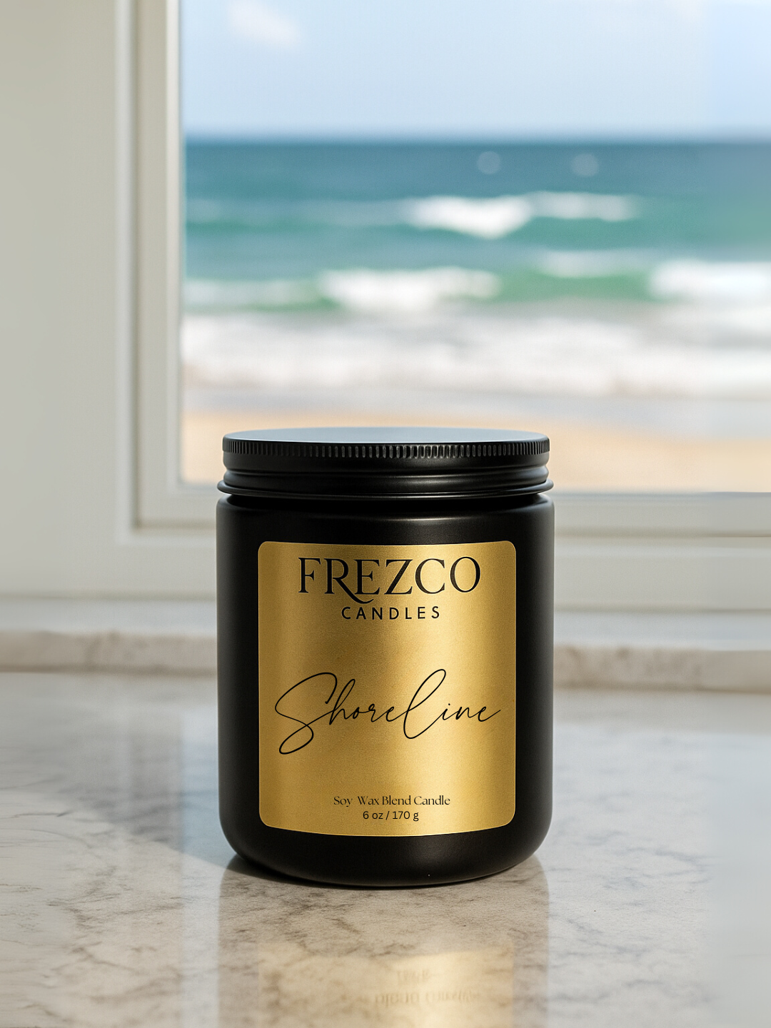 Frezco Candles Shoreline candle on a marble surface with a beach view in the background