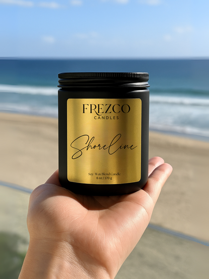Frezco Candles Shoreline candle held in front of a beach