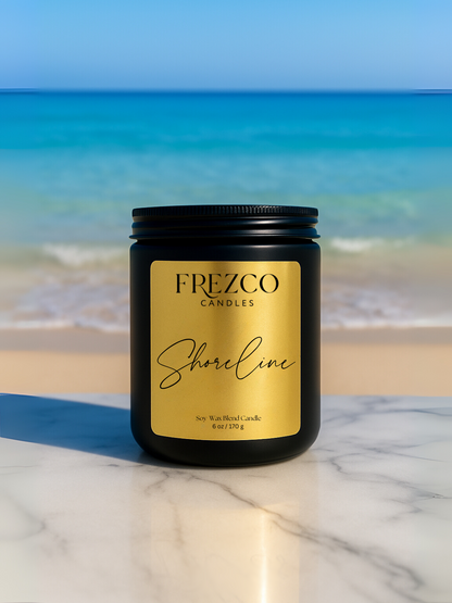 Frezco Candles Shoreline candle on a marble surface with ocean view
