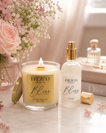 Frezco Bliss candle and spray on a table with flowers and books in the background