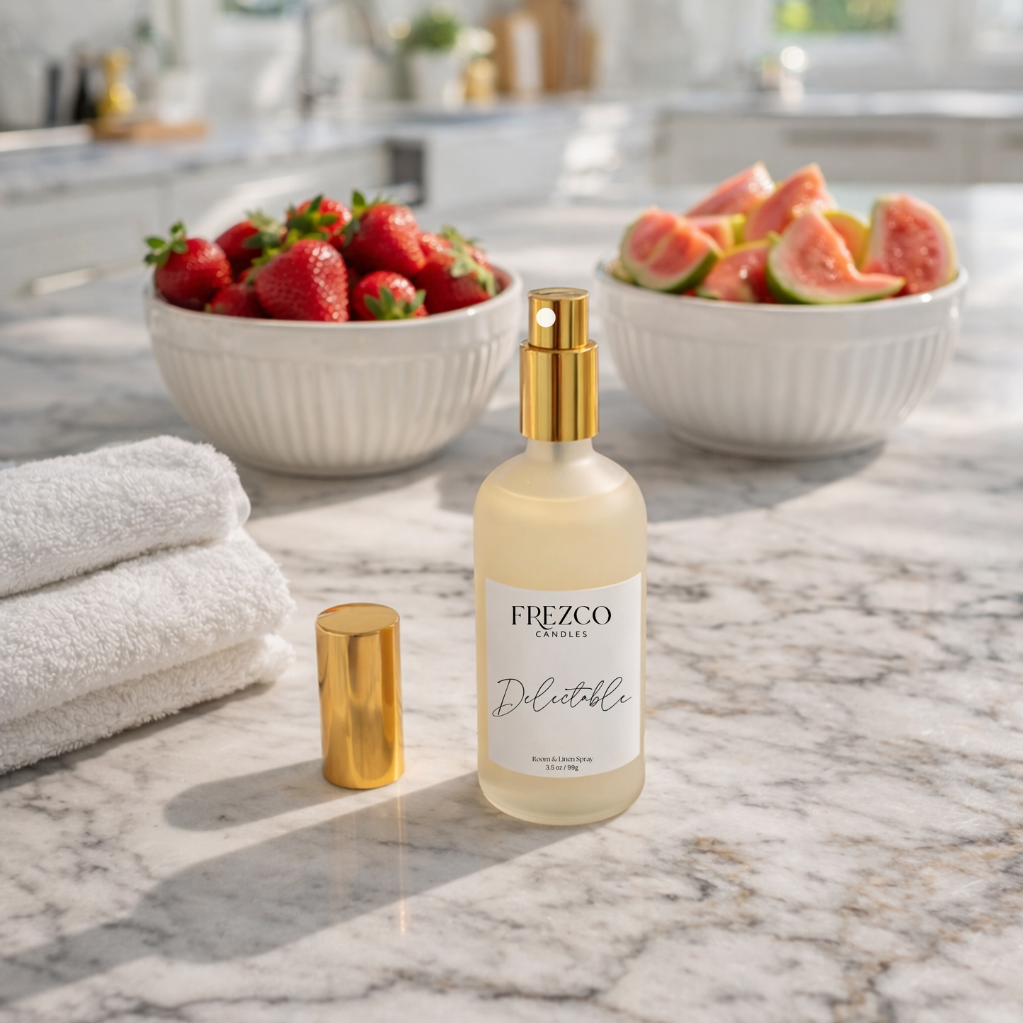 Frezco Candles Delectable spray bottle on a marble surface with fruit and towels in the background