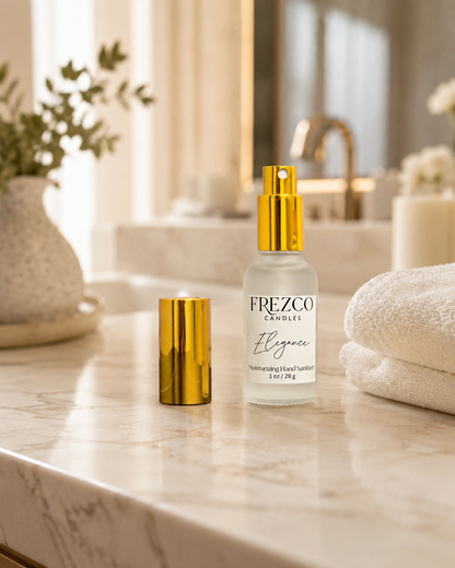 A bottle of Frezco Scentz 'Elegance' moisturizing hand lotion stands on a marble bathroom counter next to its gold cap, with folded white towels and a blurred bathroom background.