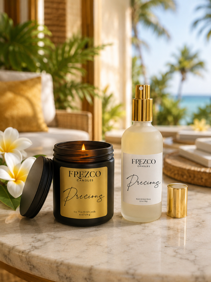 Frezco candles and spray bottle on a marble surface with a tropical background